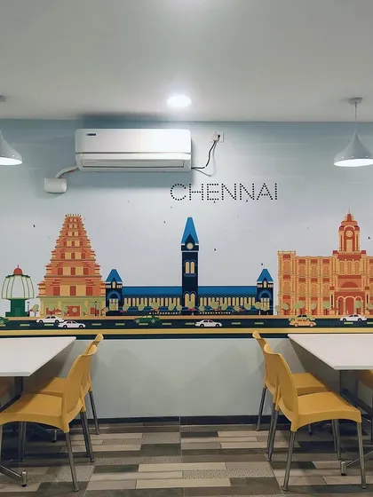 A full view of the Chennai-themed mural in the TVS canteen. This custom artwork provides a strong visual anchor for the space and fosters a sense of local pride among employees.