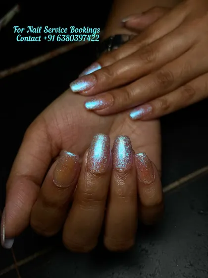 The light catching the iridescent pearl finish on these custom nail extensions. This angle shows the beautiful blue and pink shift of the holographic powder.