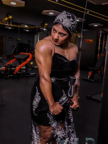 A focused moment on the cable machine. Even in a dress, my form and concentration show my dedication to training. Every rep counts.