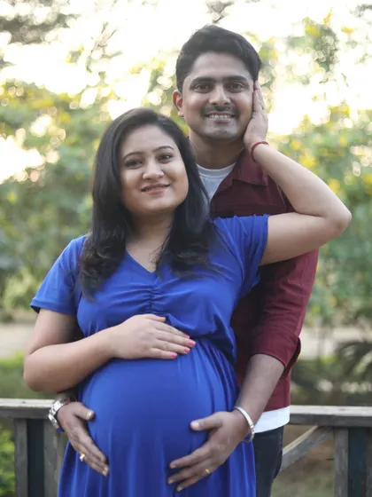 A lovely portrait of the expecting couple. The makeup is natural and enhances her features beautifully.