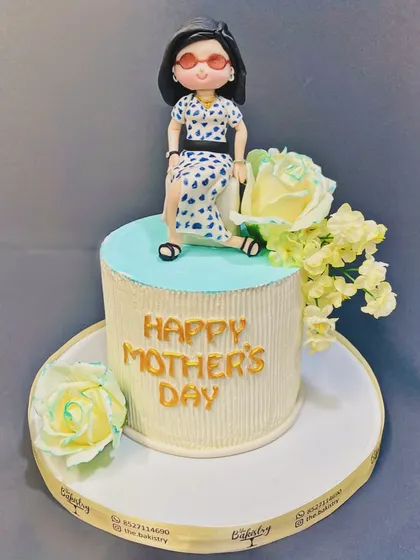 A stylish cake for a cool mom on Mother's Day, with a custom figurine topper and delicate sugar flowers.