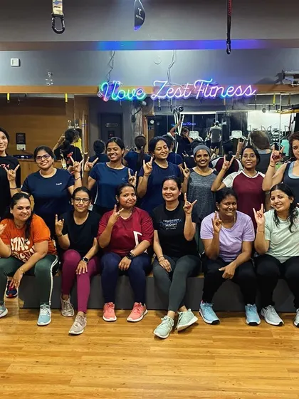 The "I love Zest Fitness" sign says it all. Our members showing their love for the community and the progress they make together.