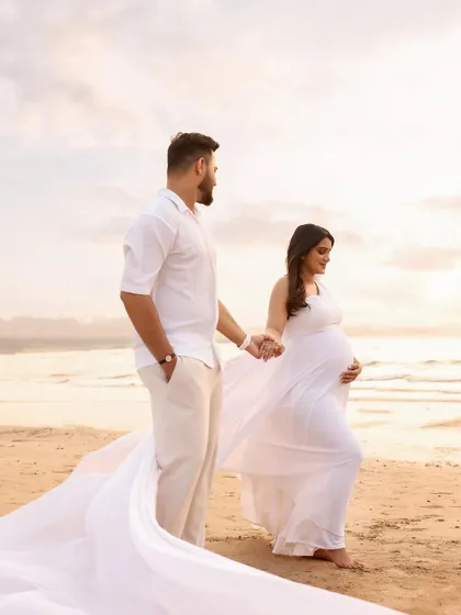 Walking hand-in-hand along the shore, this photo captures a quiet, shared moment of reflection and anticipation. The flowing gown adds a touch of elegance to the natural setting.