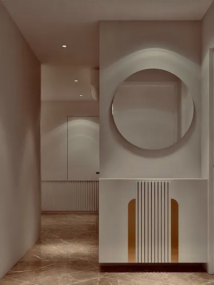 A minimalist passage that feels like an art gallery. The design uses clean lines, a circular mirror, and a sleek console with gold and fluted details to create an elegant and uncluttered walkway.