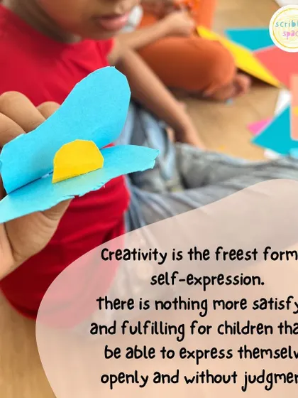 A child creating a 3D flower. Process art isn't limited to painting; it includes sculpture, collage, and any form of hands-on making.