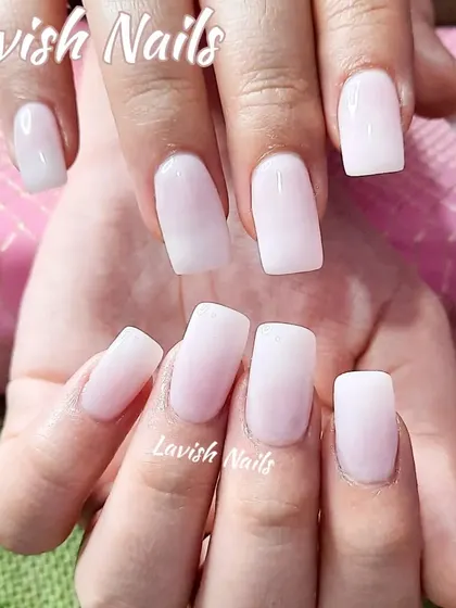 A simple and clean set of milky white square nails.