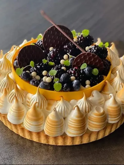 A gorgeous blackberry and blueberry tart with a torched meringue crust. This dessert is a perfect balance of sweet and tart, and a visual showstopper.