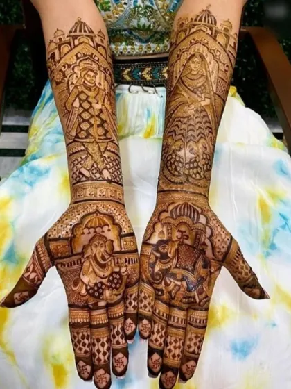 This design is filled with traditional wedding imagery, including a bride in a palanquin, Ganesha, and elephants.