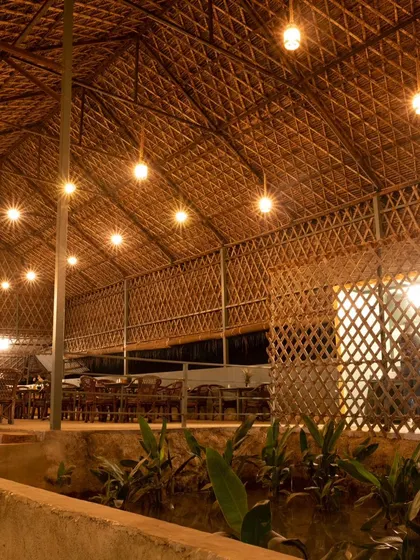 The interior of our main dining hall at night. The thatched roof and warm lighting create a rustic yet comfortable environment for your team to enjoy their meals together.