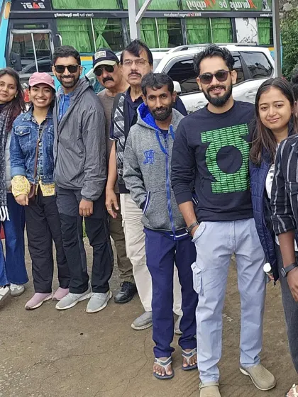 Our group posing by the bus during a break. The journey to and from the trek location is an integral part of the experience.