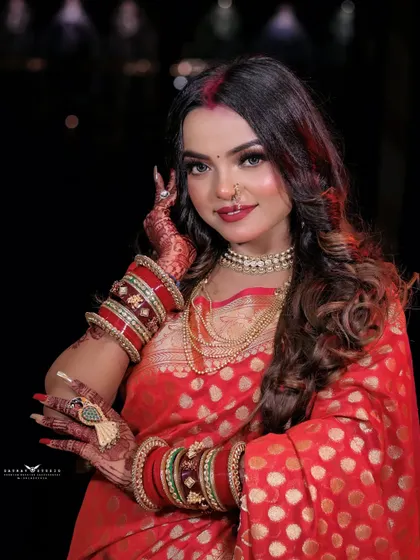 A happy and festive portrait. The model's pose, with her henna-adorned hands, and her bright smile perfectly capture the celebratory spirit of Karwa Chauth.