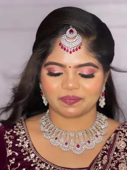 A detailed shot of the eye makeup, featuring a beautiful blend of pink and silver shimmer that makes her eyes sparkle.