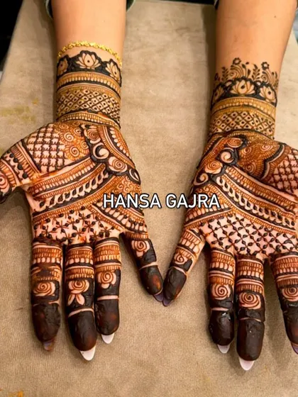 A bolder, more geometric design for a family member who wants a modern yet traditional look. The contrasting patterns and dark fingertips make this a striking choice for any celebration.
