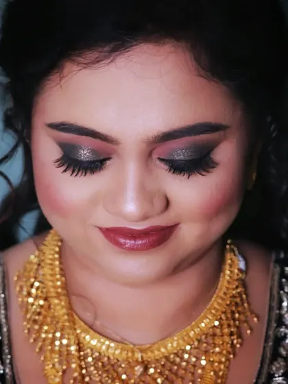 A close up of Afreen's reception eye makeup. This dramatic smokey eye uses a blend of black and silver glitter to create a captivating and glamorous look perfect for an evening event.