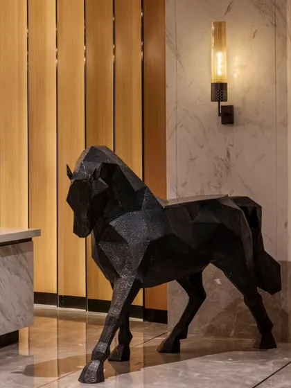 A bespoke, geometric horse sculpture stands as a key art installation in the Radisson Resort lobby. This piece adds a strong visual anchor and reflects the project's commitment to integrating unique, contemporary art within the hospitality space.