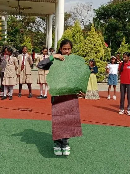 A student dressed as a tree delivers a powerful message about the importance of forests during the World Environment Day skit.