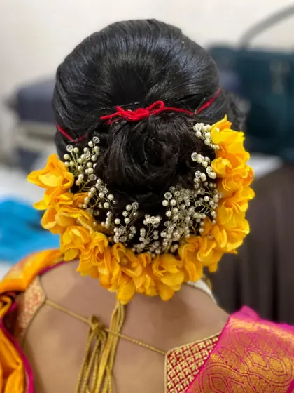 Another view of this classic floral bun. The combination of fresh flowers and traditional hair accessories is a hallmark of a Maharashtrian bridal hairstyle.