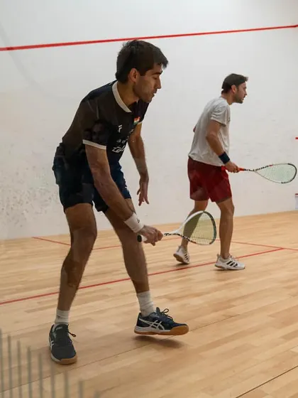 Ramit Tandon in action during a professional PSA tour match. This image captures the focus and intensity required to compete at the highest level of international squash.