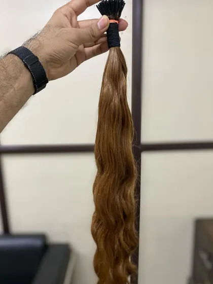 This is a bundle of our wavy I-Tip extensions in a beautiful light brown shade. The quality of the 100% human hair ensures it can be styled and treated just like natural hair.