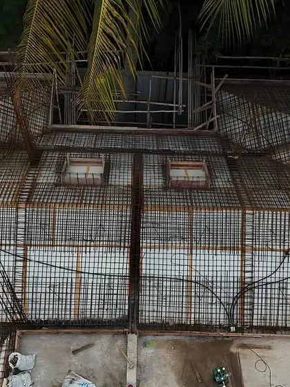 A close-up aerial view of the rebar work on a complex roof, showcasing the intricate engineering behind the design.