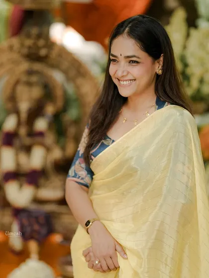 A candid moment of joy. She looks so effortlessly beautiful in this setting, highlighting how my sarees are perfect for celebrating life's happy occasions.