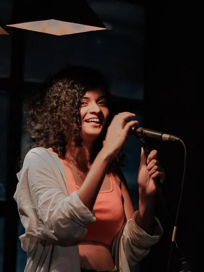 Sharing a laugh on stage. I love keeping my performances real and goofy, just like I am with my friends.