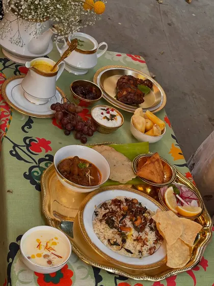 Our Eid table tells a tale of ancient spice routes, from Arab sails to the Malabar shores. This lavish spread includes aromatic biryani, rich curries, roasted chicken, and fresh fruits, celebrating the culinary history of the Mappila community.