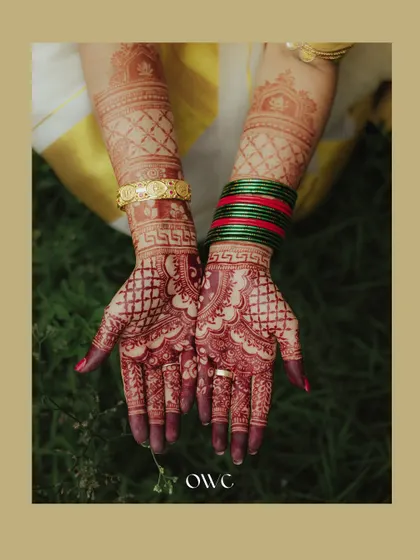 A detailed shot of the bride's hands, showcasing the intricate and beautiful mehendi design.