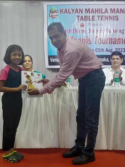 Kshiti Sawant receives her trophy for winning a bronze medal in the U-11 category at the 4th District Ranking tournament.