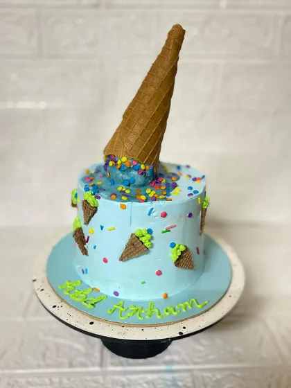A full view of the playful and delicious-looking ice cream cone cake.