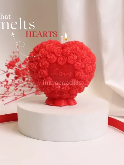 A light that melts hearts. This intricately designed red heart candle, covered in tiny roses, is a statement piece for Valentine's Day. It's almost too pretty to light.