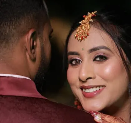 A candid shot of the bride looking over her shoulder. Her makeup looks flawless and natural, even from a distance.