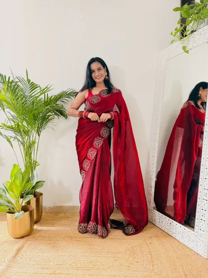 This deep maroon velvet-finish saree from Flipkart is perfect for winter festivities or a wedding reception. The embroidered border adds a touch of richness, making it look very luxurious.