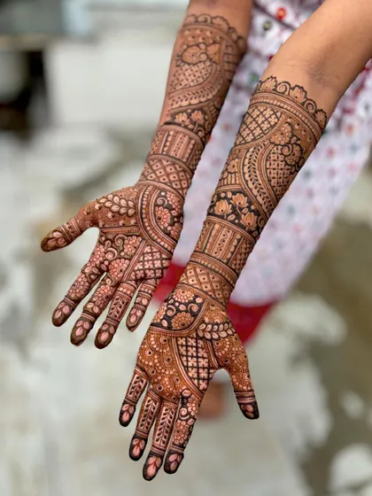 A full-coverage bridal design with a focus on intricate, flowing patterns.
