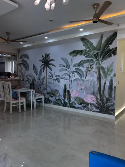 A clearer view of the finished accent wall with flamingo and palm tree motifs. This kind of feature wall can completely transform the feel of a living room.