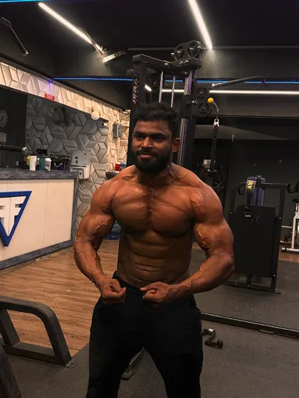 A front double bicep pose from one of my athletes, showing impressive size and definition.