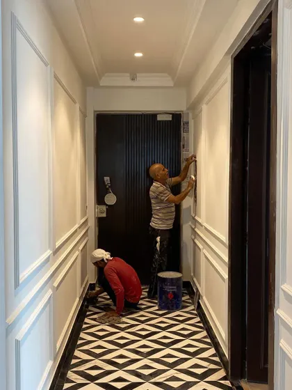 Our team giving the final touches to the foyer wall panels, showcasing our on-site attention to detail.