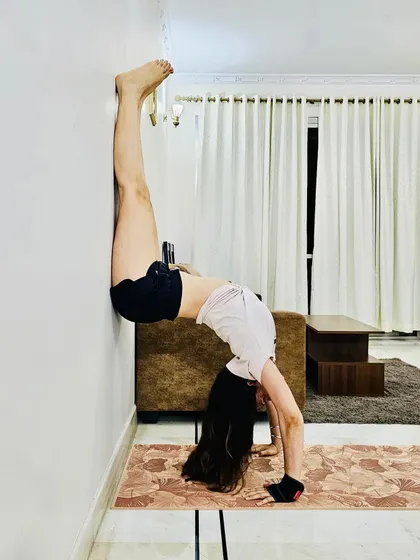 Backbend with feet walking up the wall, a deeper way into the wheel.