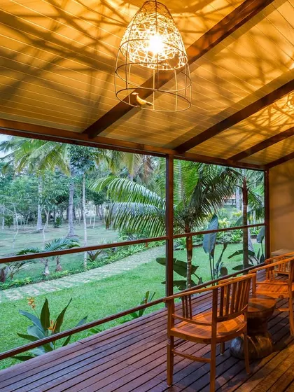 A spacious balcony with comfortable seating, perfect for enjoying the evening breeze and garden views.