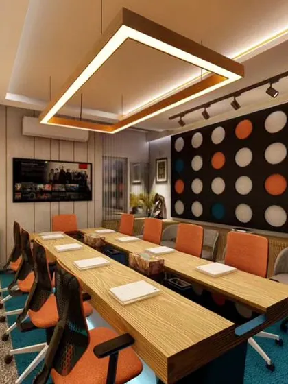 We designed this modern conference room to be both functional and visually engaging. The space features a bold, graphic feature wall, layered lighting with both track lights and a central fixture, and comfortable seating to facilitate productive meetings.