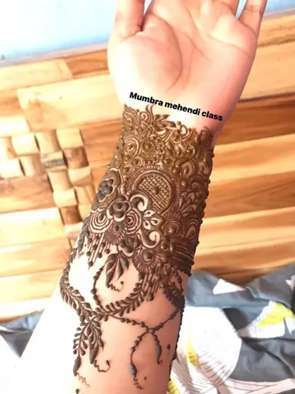 A close-up of the intricate cuff portion of the cutwork design.
