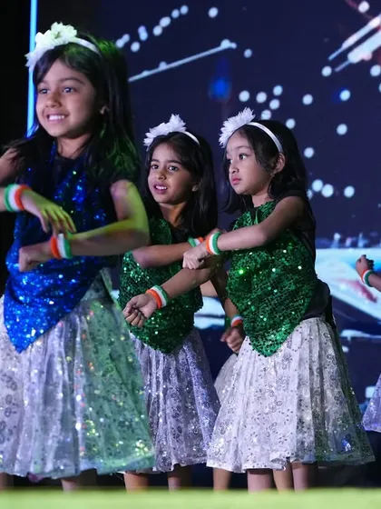 A patriotic dance performance for Annual Day, with children dressed in the colors of the flag.