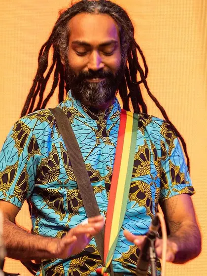 In my element, feeling the rhythm. I learned from my guru, Mamady Keïta, that the djembe is a universal language. My passion is sharing that language and the joy it brings, whether on a big stage or in an intimate circle.