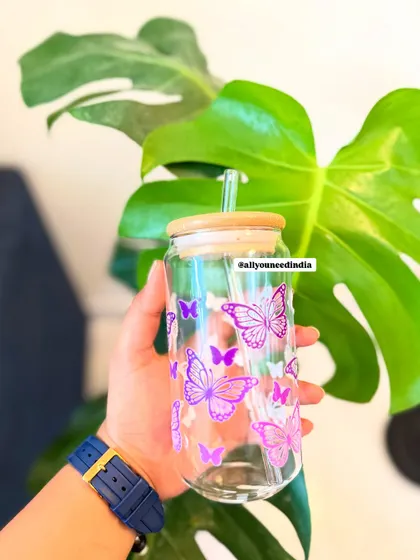A simple yet elegant glass sipper with a purple butterfly design.
