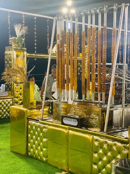 Our elegant gold-padded barbecue station, showcasing a unique vertical kebab display.