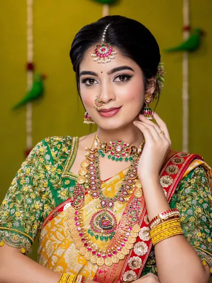 A close-up of the bride's happy expression. The maang tikka and nose ring complete this traditional look, perfect for a wedding or festive occasion.