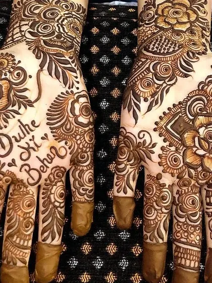 Making the groom's sister feel special with this "Dulhe Ki Behen" mehendi. It's a fun way to celebrate family at a wedding.