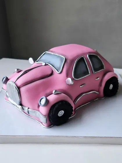 Another view of the pink vintage car cake. Sculpting cakes like this is a true passion, combining technical skill with artistic vision.