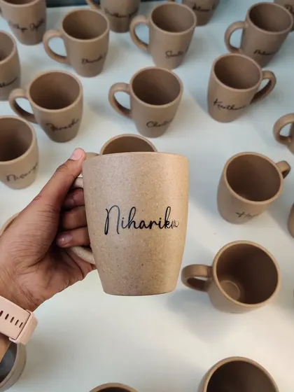 A closer look at one of our personalized bamboo husk mugs, showing the natural texture and elegant custom script.