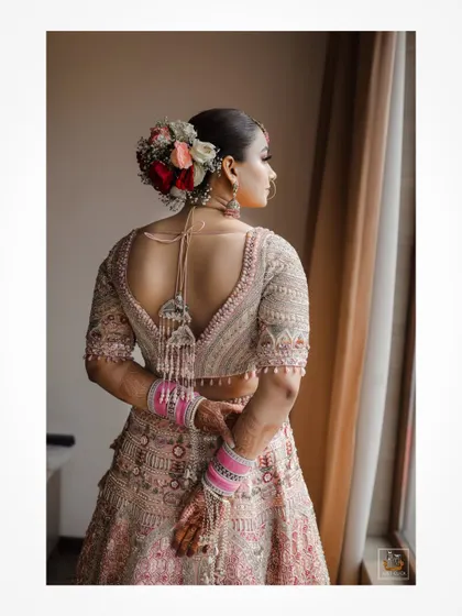 A beautiful shot of the bride looking out the window, capturing a moment of quiet anticipation.